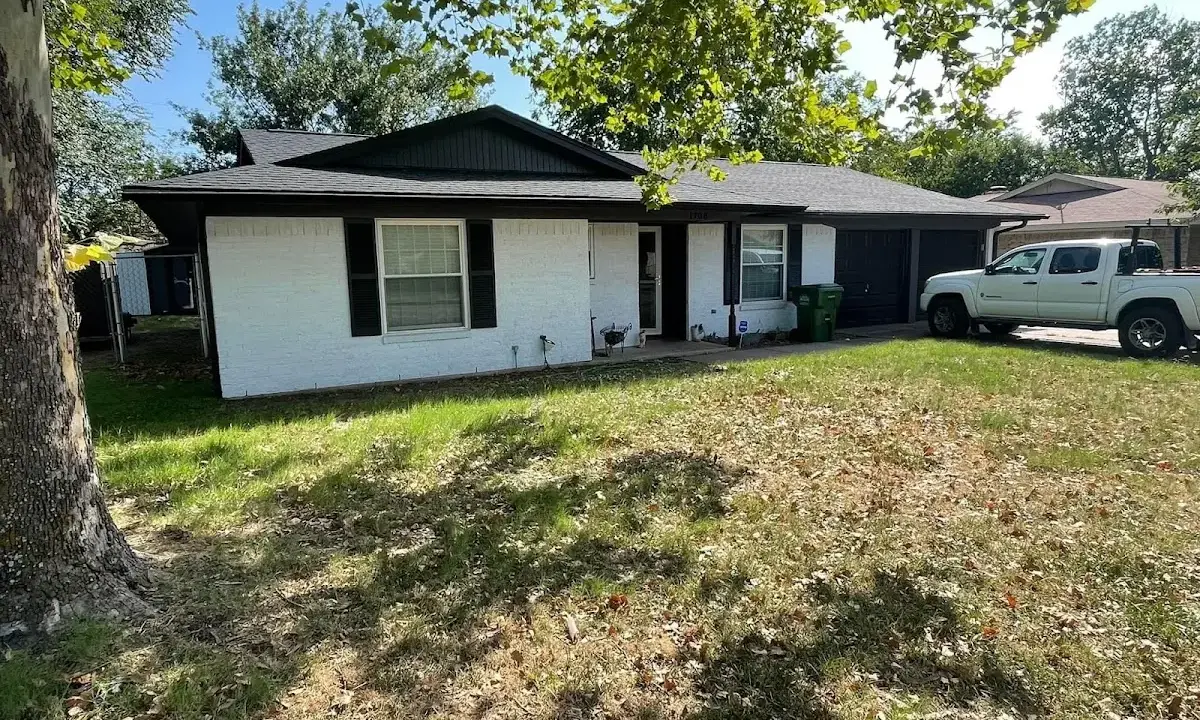 Professional roofing crew working on a residential roof in Ojus